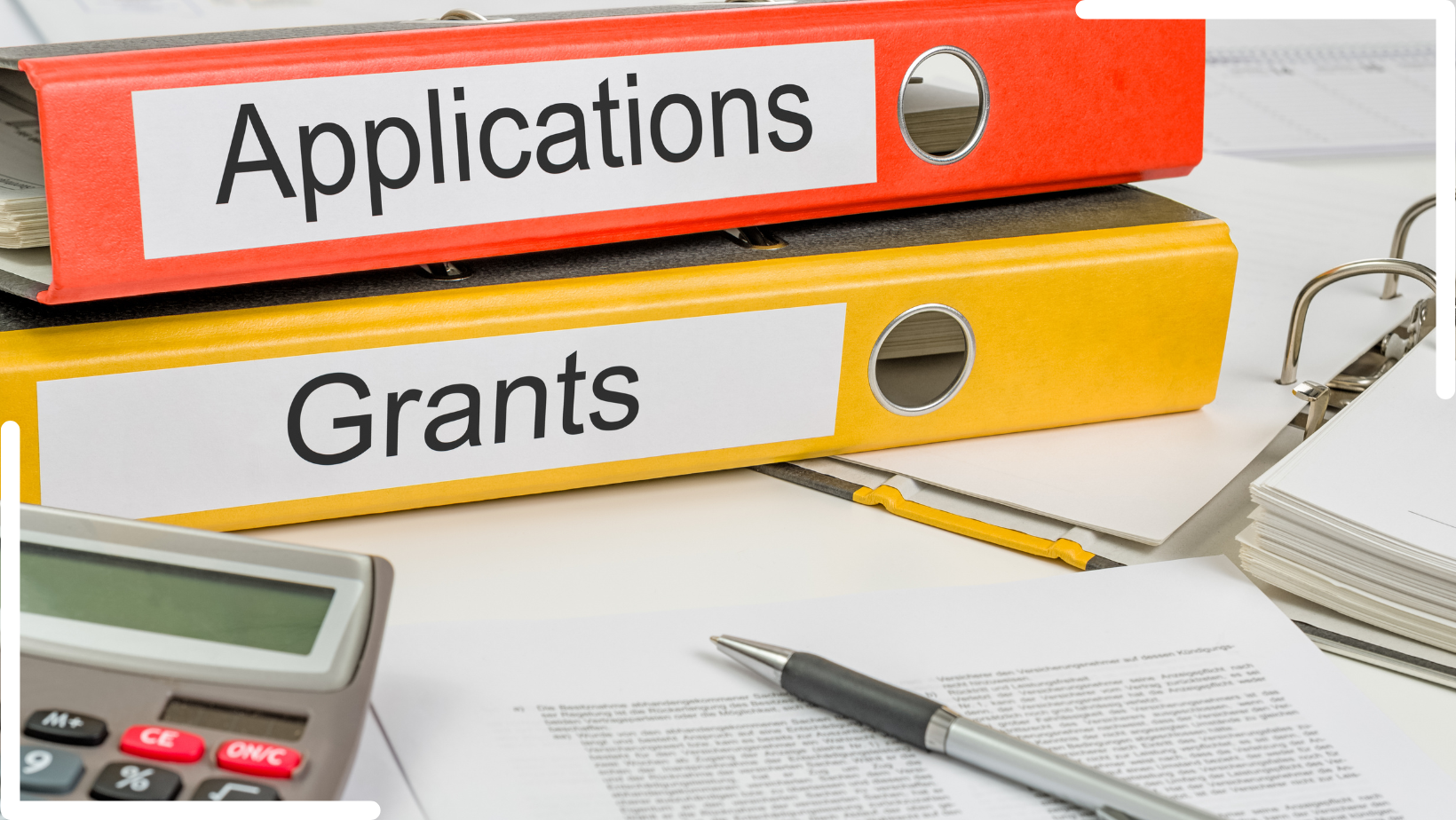 grants and apps work desk with binders spelling application and grants