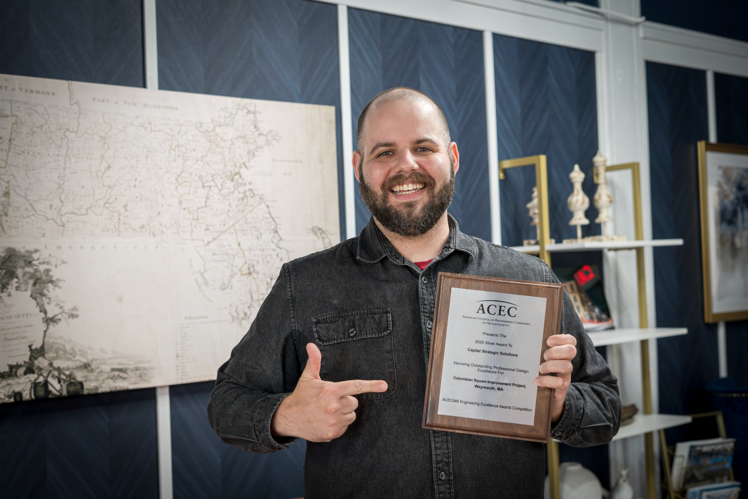 Mike Tusino of Capital Strategic Solutions holding the ACEC Massachusetts Silver Award